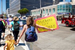 Kristin marching with a Mothers for Nuclear sign
